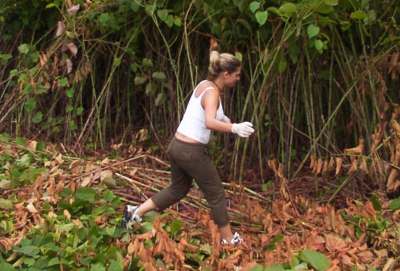 Leader Bethany Shaw, here working amidst tall bamboo, gets dirty right along with everybody else.