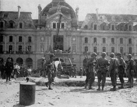 French civilians and men of the 8th Division look at the damage caused during the liberation of Rennes, France from German yoke.